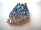 A rock with deep blue and some green encrustations
