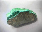 A green rock with dark marbling